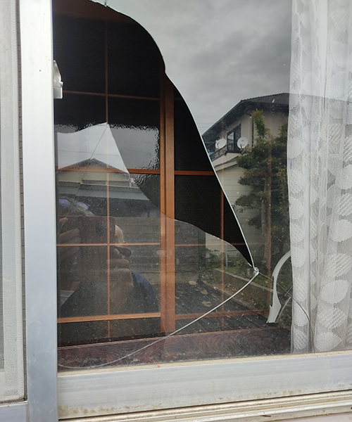 戸建て住宅の割れた窓ガラス